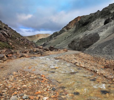 National Park Landmannalaugar in Iceland. Creek in the gorge between the mountains of black