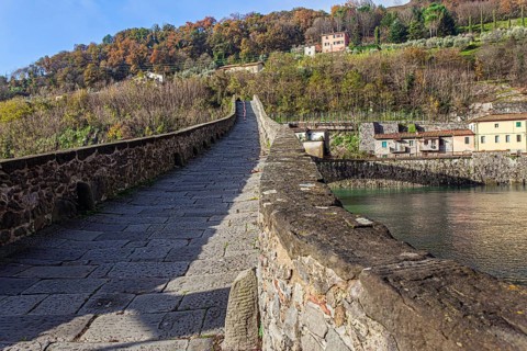Picturesque stone bridge built a thousand years ago. Devil's Bridge over the Sercchio River. Cold