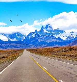 The road to the famous Mount Fitzroy. The famous peaked rock monoliths are illuminated by the sun.