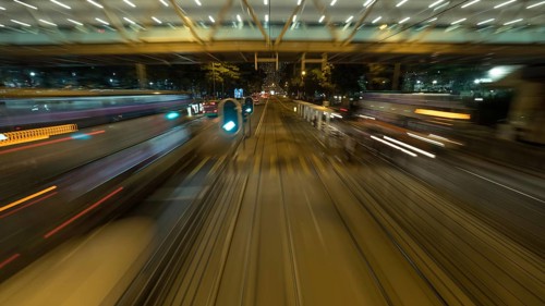 View to the road and transport from moving double-decker train. Shot in motion, Hong Kong, Asia