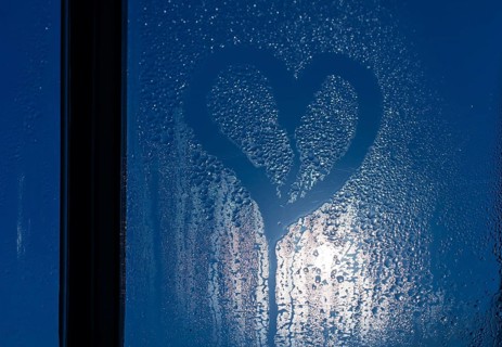 Moonlight through the window. Sweaty glass and heart shape