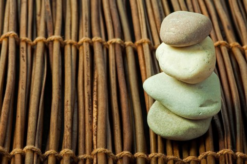 Stacked stones on wooden base. Studio shot
