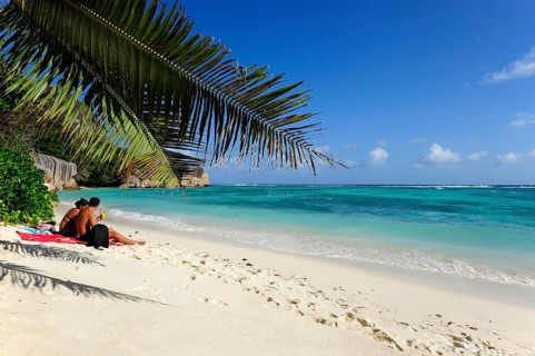 Couple on the beach Anse Source a Jean, Union Estate National Park, La Digue Island, the