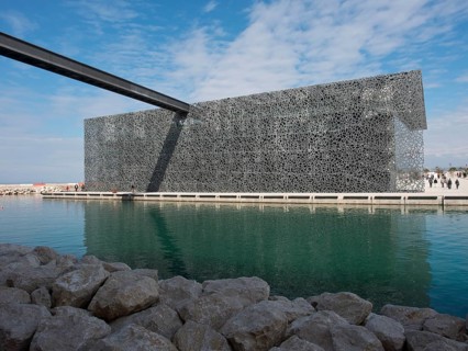 Metal decorated modern building in a watery environment under a blue sky, marseille, mediterranean