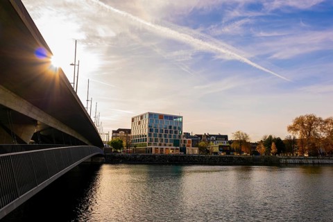 Modern Building and a Bridge over River Aare with Sunbeam in a Sunny Autumn Day in Solothurn,