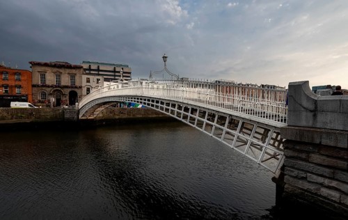 Dublin, Ireland, UK, June 19, 2022: Famous landmark of Ha' penny bridge over the river liffey