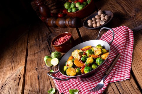 Brussels sprouts potato pan with bacon in a rustic style