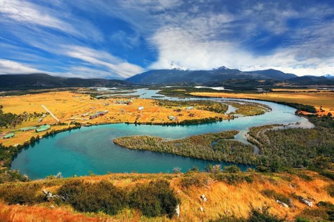 Meandering river bed of yellow autumn coast. Glen Serrano