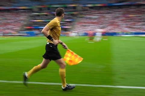 Soccer sideline referee runs during the match - intentional blurry