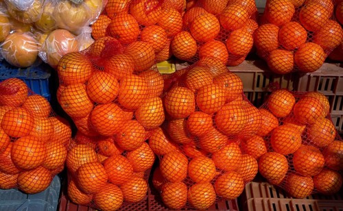 Oranges from Mediterranean in net bags at the outdoor market