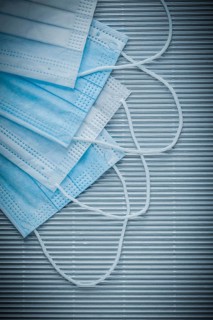 Set of medical disposable face masks on striped background