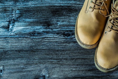 Safety boots on vintage wooden board