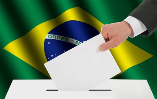 The Brazilian flag and the hand with the bulletin about the ballot box