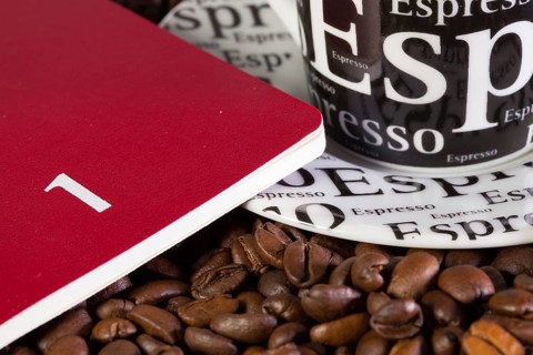 Coffee beans, cup of coffe and diary for January