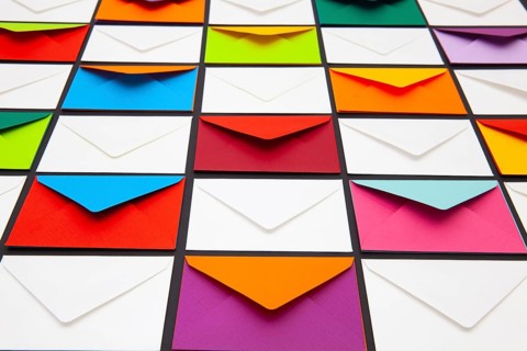 Composition with white and colored envelopes on the table. The photo suitable for various holidays