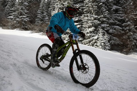 Sofia, Bulgaria - 22 January, 2022: Cyclist rides a bike downhill during an extreme snow riding