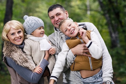 Close up portrait of a young family in the autumn park