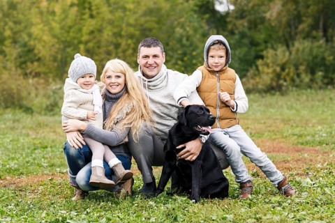 Happy family with dog on nature