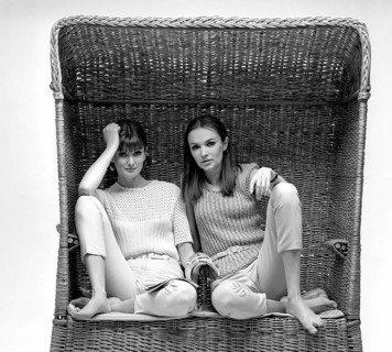 In the 1960s. Two fashion models, in typical 1960s summer outfits photographed in a studio wearing