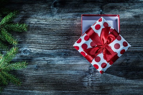 Present box fir tree branch on vintage wooden board