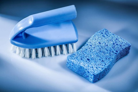 Plastic brush sponge on white background