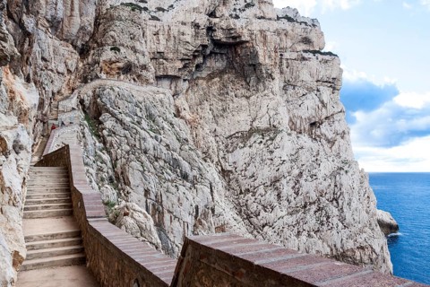 The incredible staircase of Neptuno cave in the morning. Alghero, Sardinia. Italy