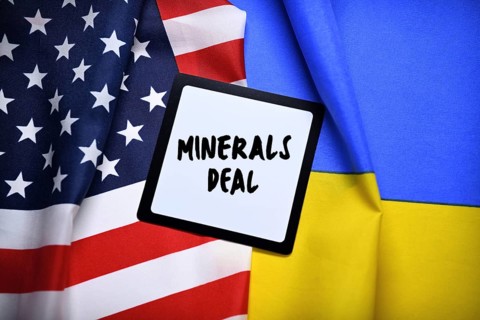 The flags of Ukraine and USA with plaque and inscription minerals deal, photomontage