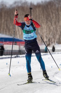 Sportsman biathlete Kapustin Aleksandr skiing on ski track distance biathlon stadium during Junior