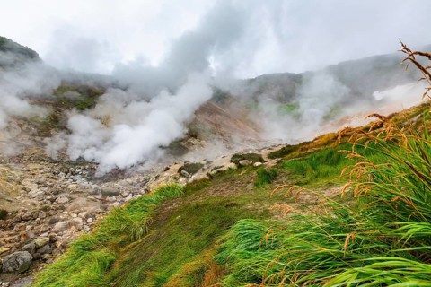 Thrilling view of volcanic landscape, aggressive hot spring, erupting fumarole, gas-steam activity