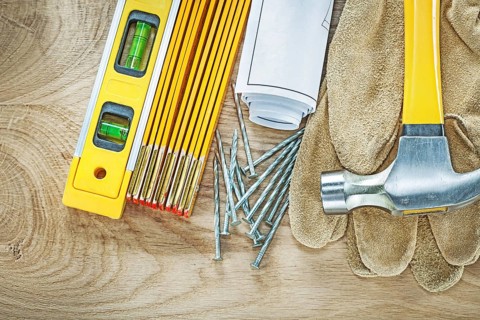 Blueprints construction level safety gloves wooden meter claw hammer nails building concept