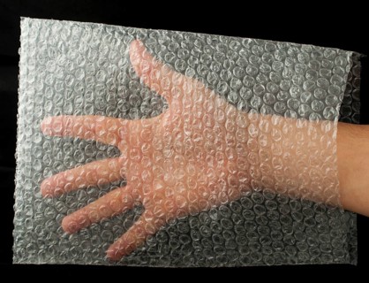 Plastic bag and hand inside. Black isolated