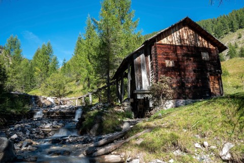 An old wooden watermill in Val di Morins, the Dolomite Alps of South Tirol
