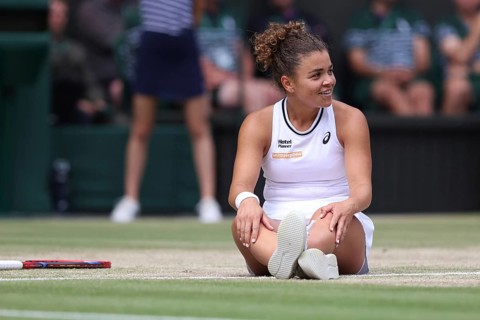 Italian tennis player Jasmine Paolini sitting on the ground after a fall at the 2024 Wimbledon
