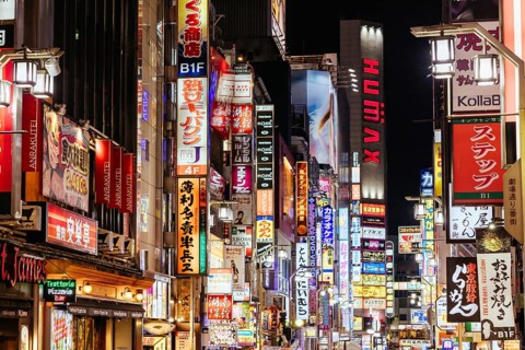 TOKYO, JAPAN - MAY 12, 2019: Neon signs illuminate Tokyo's busy Shinjuku neighborhood at night
