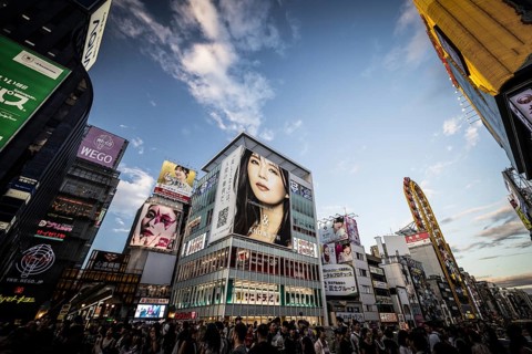 OSAKA, JAPAN - SEPTEMBER 26 2024: The view down Dotonbori River from Ebisubashi Bridge on a clear