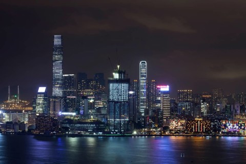 Symphony of Lights in night Hong Kong. Illuminated skyscrapers and colorful reflection in water