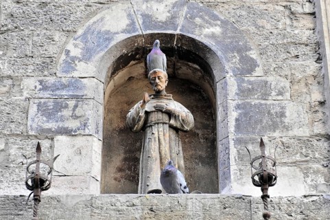 Assisi, Umbria, Italy, Europe, stone altar with a statue of a saint in the niche, decorated with