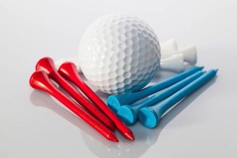 Different golf equipments on the glass table