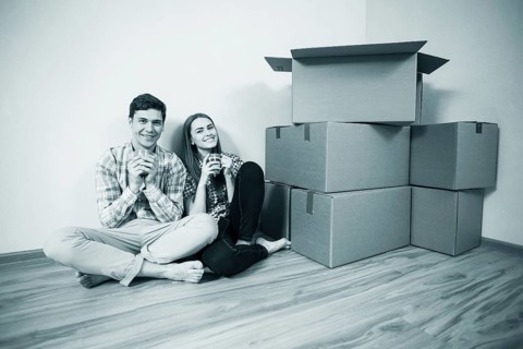 Relocated couple drinking tea on the floor