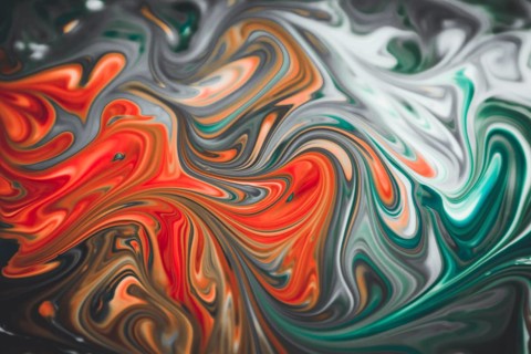 Colorful liquid paints mixed together creating modern abstract
