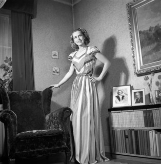 Fashion of 1946. A woman pictured wearing the typical fashion of the postwar era. She is wearing a