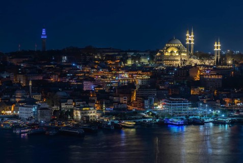 A picture of the Suleymaniye Mosque and the Golden Horn waterfront at night