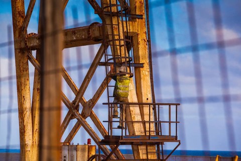 Worker climbing on a crane