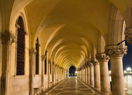 Illuminated archway of the Palazzo Ducale at night, Venice, Italy Venice, Italy, Europe