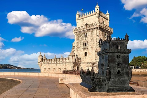 Belem tower and its scale model, Lisbon, Portugal at blue summer day sky with clouds. Medieval fort