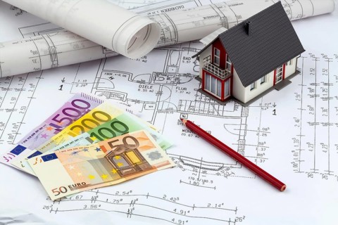 An architect's construction plan with euro money. Symbolic photo for financing and planning a new