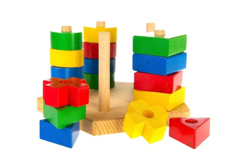Colorful wooden baby toys isolated over white