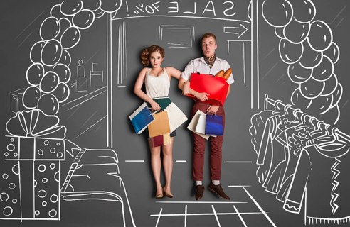 Love story concept of romantic couple on shopping against chalk drawings background. Young couple