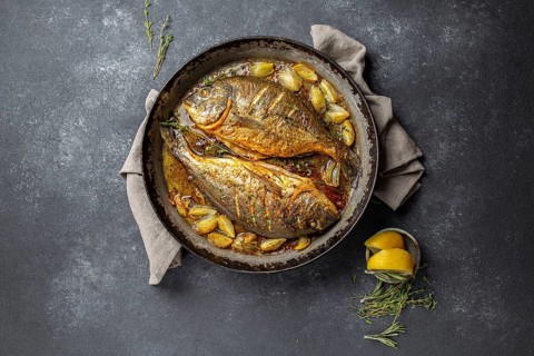 Food, Food, Baked sea bream or dorada with onion and herbs in pan on dark background