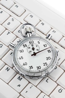 A stopwatch lies on a computer keyboard. Working time is money Austria
